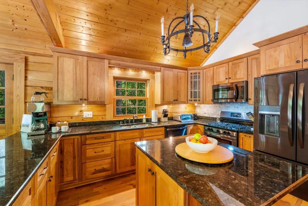 Fully equipped kitchen with granite counters, gas range, and Bunn dual-pot coffee maker